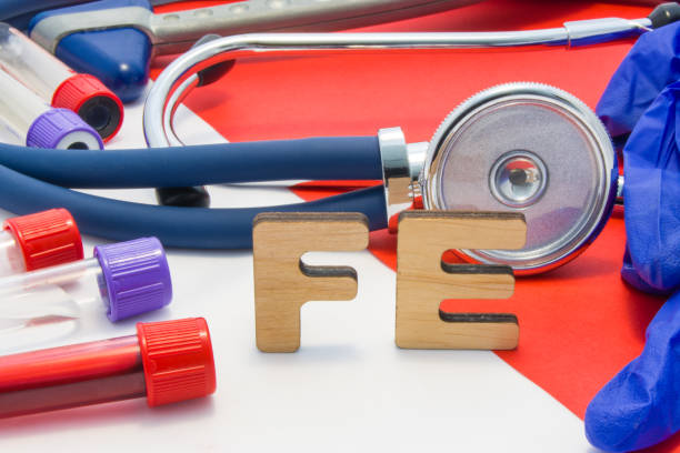 FE medical abbreviation meaning total iron or ferrum in blood in laboratory diagnostics on red background. Chemical name of FE is surrounded by medical laboratory test tubes with blood, stethoscope FE medical abbreviation meaning total iron or ferrum in blood in laboratory diagnostics on red background. Chemical name of FE is surrounded by medical laboratory test tubes with blood, stethoscope red blood cell photos stock pictures, royalty-free photos & images