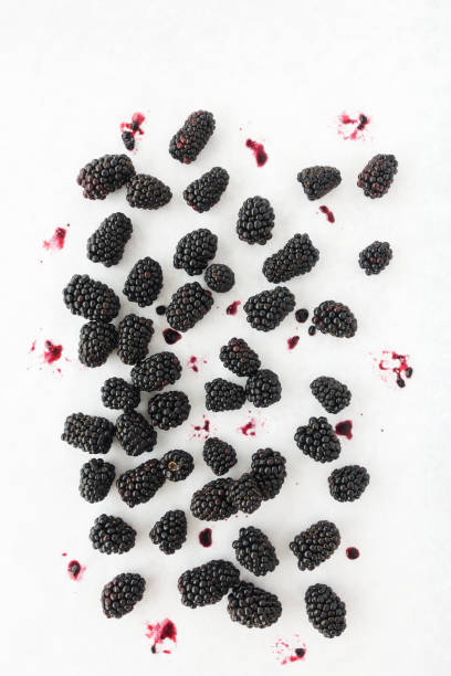 istock Top View of Blackberries Scattered on White Background 1129611688