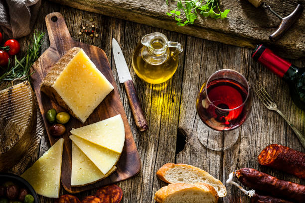 istock Spanish food: Manchego cheese, spanish chorizo and red wine on rustic wooden table 1129611903