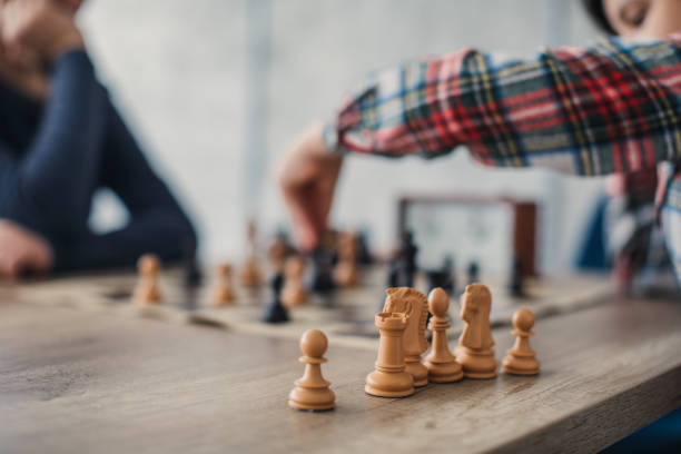 istock Two boys playing a game of chess 1129612863