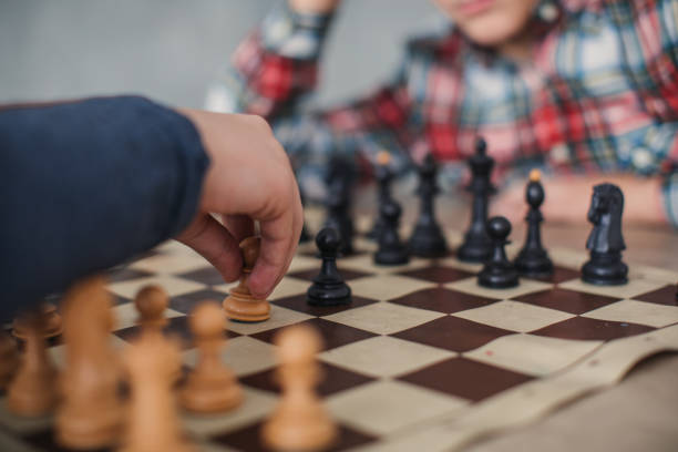 istock Boys playing a game of chess 1129613262