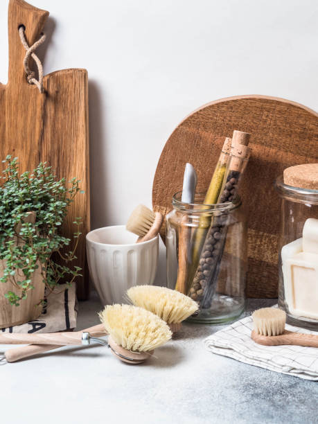 istock Zero waste concept. Eco-friendly kitchen set. Brushes, soap in jar, spices in glass tubes and plant in wood flowerpot 1129613301