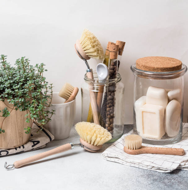 istock Zero waste concept. Eco-friendly kitchen set. Brushes, soap in jar, spices in glass tubes and plant in wood flowerpot 1129613302