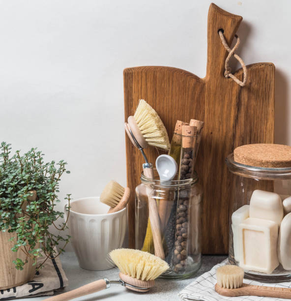 istock Zero waste concept. Eco-friendly kitchen set. Brushes, soap in jar, spices in glass tubes and plant in wood flowerpot 1129613303