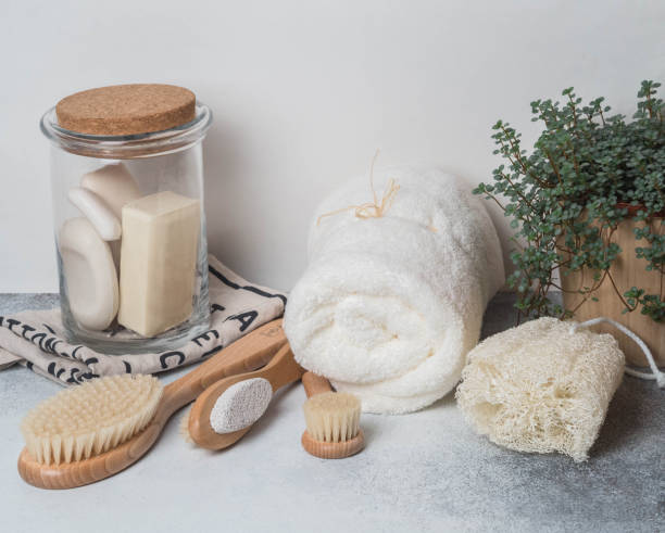 istock Zero waste concept. Eco-friendly bath set. Brushes, soap in jar, towel, pumice and bast and plant in wood flowerpot. Copy space 1129613360