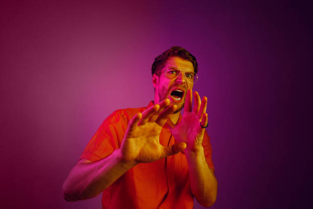 istock Portrait of the scared man on pink 1129613519