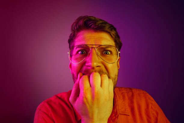 istock Beautiful man looking suprised and bewildered isolated on pink 1129613525