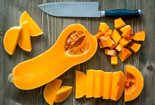Butternut squash on a rustic wooden surface.