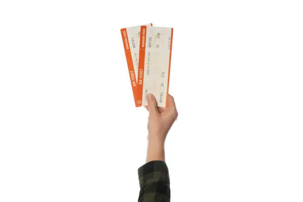 Air ticket in hand isolated on white background. Planning trip, summer vacation.