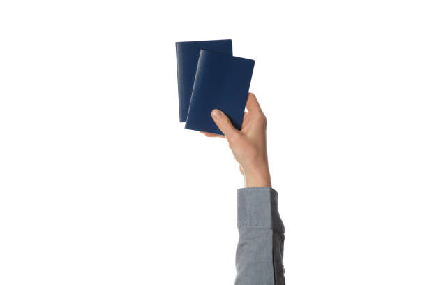 istock Blue passport in hand isolated on white background. Customs control and travel 1129618657