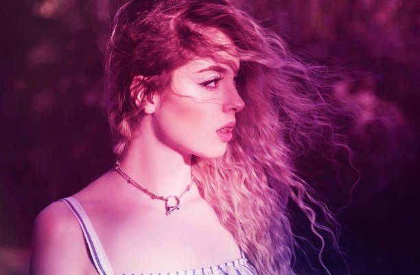 istock Young woman in vibrant light 1129620427