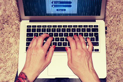 A woman on the computer and login with password and username