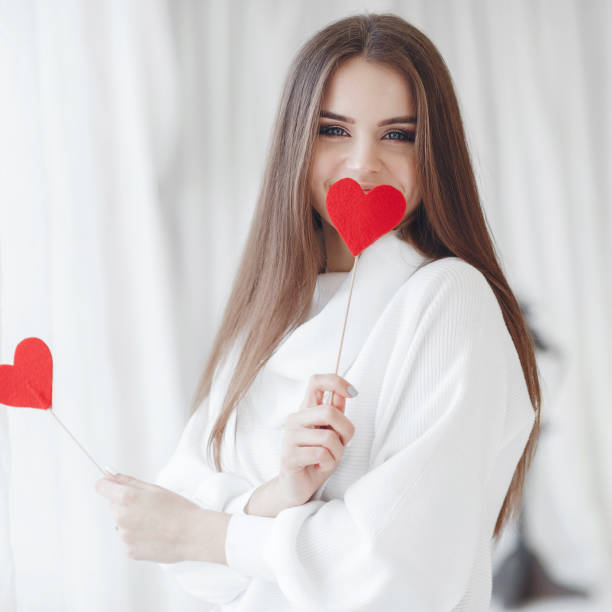 istock Beautiful woman congratulates with valentine's day isolated on white 1129621514