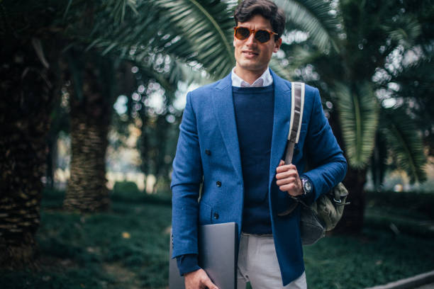 istock Modern businessman walking in the park 1129622344