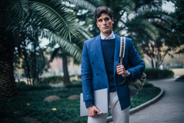 istock Modern businessman with backpack and laptop 1129622510