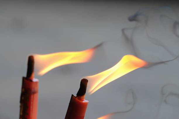 istock Flame and smoke from burning red candles 1129623666