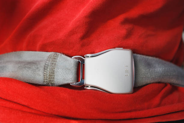 istock fasten seat belt in the airplane 1129623741