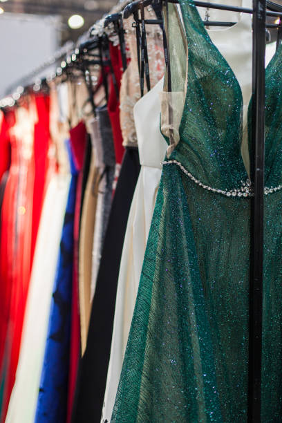 istock Glittering evening dresses in the store. 1129624585