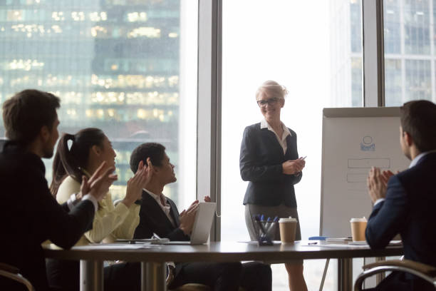 istock Diverse grateful businesspeople applaud to speaker congratulating with presentation 1129629308