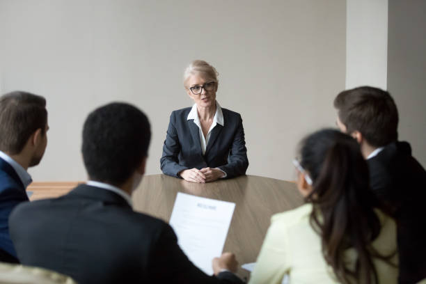istock Middle-aged confident applicant talking to hr managers during job interview 1129629330