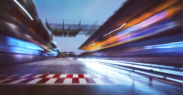racing track with motion blur Motion blurred racetrack with start or end line and  lighting effect apply . light trail photos stock pictures, royalty-free photos & images