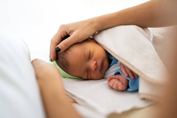 istock Mom caressing baby 1129630396