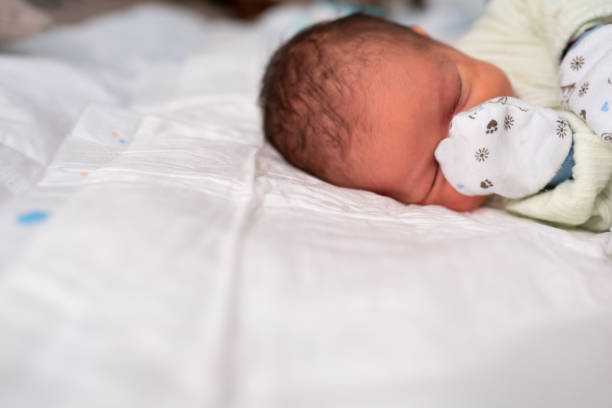 istock Baby sleeping with cotton gloves 1129631570