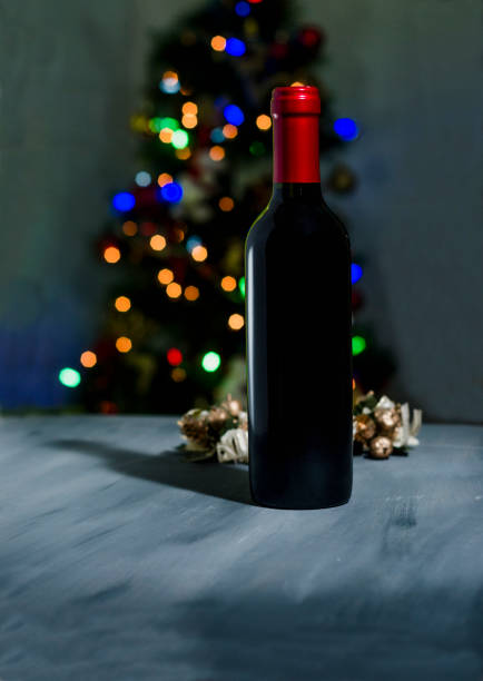 istock red wine bottle in background with colorful party lights 1129631577