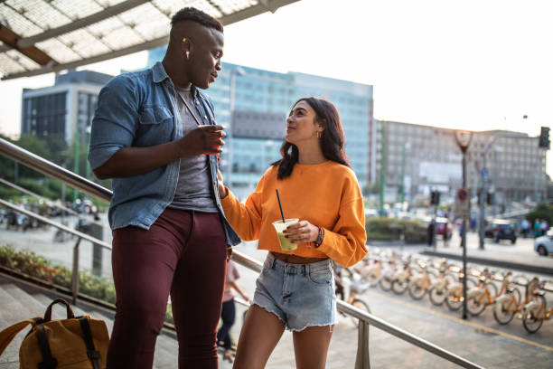 istock Interracial couple drinking juice outdoor 1129631662