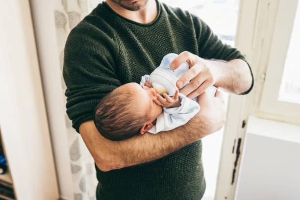 istock Father feeding newborn baby boy 1129631719
