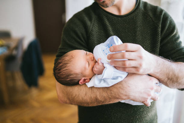 istock Father feeding newborn baby boy 1129631725