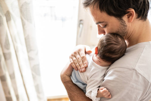 istock Newborn baby and father 1129631906