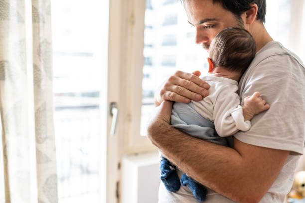 istock Dad holding  newborn baby 1129631910