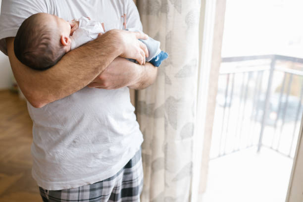istock Newborn Baby Boy in Daddy's Hands 1129631931