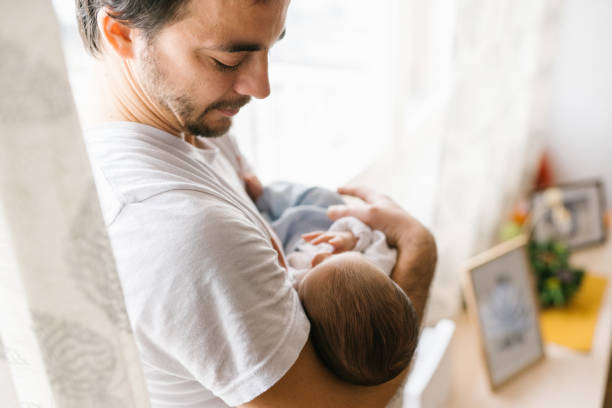 istock Dad holding  newborn baby 1129631951