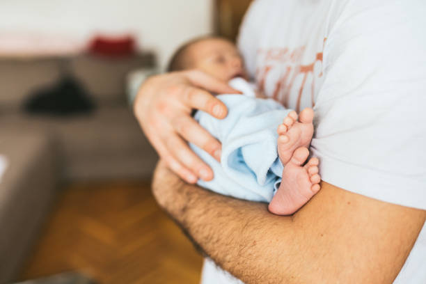 istock Dad holding  newborn baby 1129631984