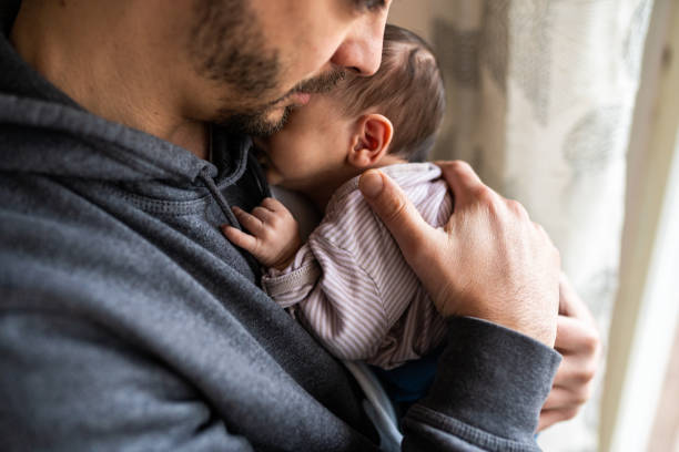 istock Proud father holding newborn son 1129631994