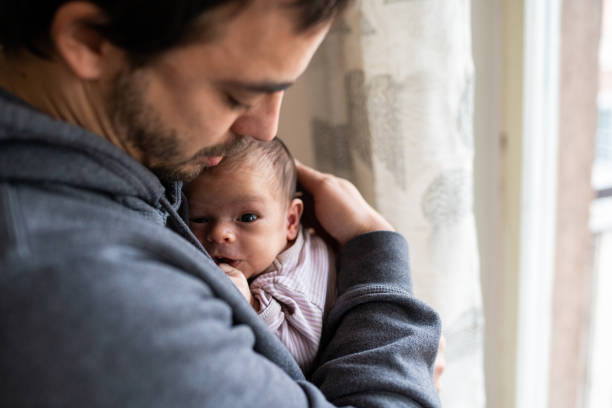 istock Proud father holding newborn son 1129632008