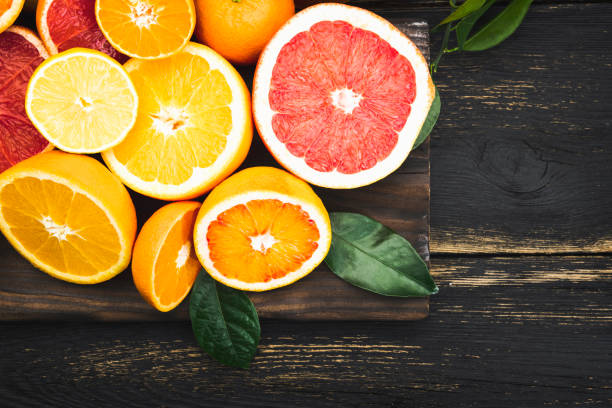 istock Fresh organic citrus fruits on rustic wooden table 1129632391