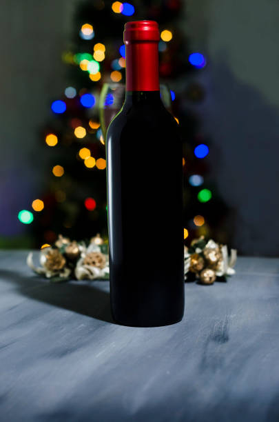 istock red wine bottle in background with colorful party lights 1129633609