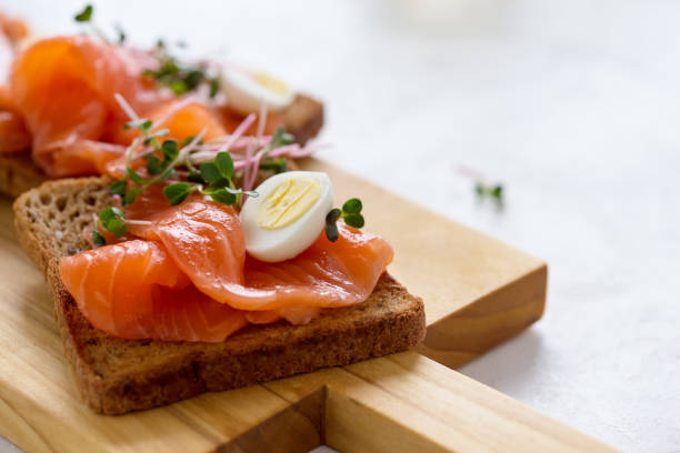 istock Toasts with smoked salmon, quail egg and radish sprouts 1129634023
