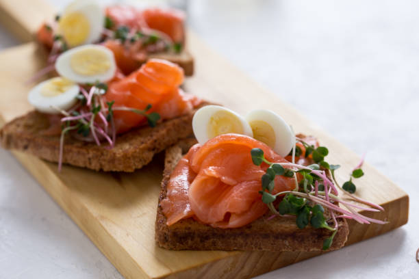istock Toasts with smoked salmon, quail egg and radish sprouts 1129634035