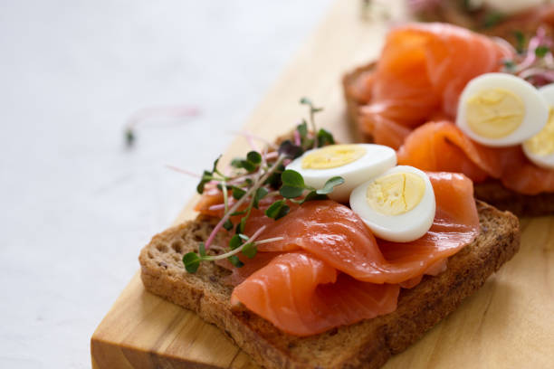 istock Toasts with smoked salmon, quail egg and radish sprouts 1129634050