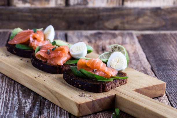 istock Toasted rye bread with  smoked salmon, spinach, avocado, and quial eggs 1129634096