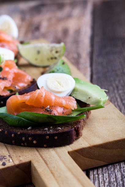 istock Toasted rye bread with  smoked salmon, spinach, avocado, and quial eggs 1129634155
