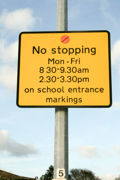 istock No stopping sign yellow outside lamp post 1129635361