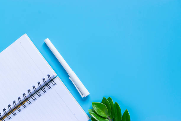 istock Top view keyboard,notebook,pen, or object for office supply concept on blue background. 1129637052