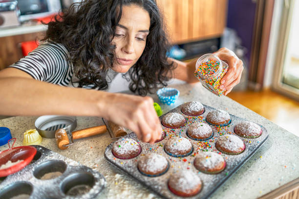 Woman decorating muffins