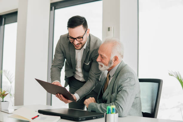 istock Business men revising paperwork 1129637558