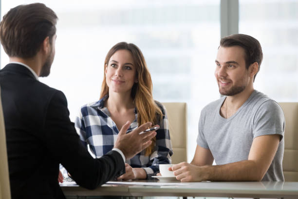 Financial advisor making presentation offer to clients at meeting Couple customers consulting Real Estate Agent lawyer or insurer about buying house or insurance services, salesman, bank worker or financial advisor making presentation offer to clients at meeting in office brokers stock pictures, royalty-free photos & images